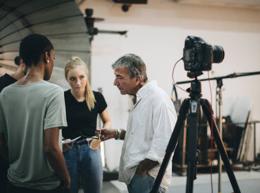 Video production director briefing crew and talent on set
