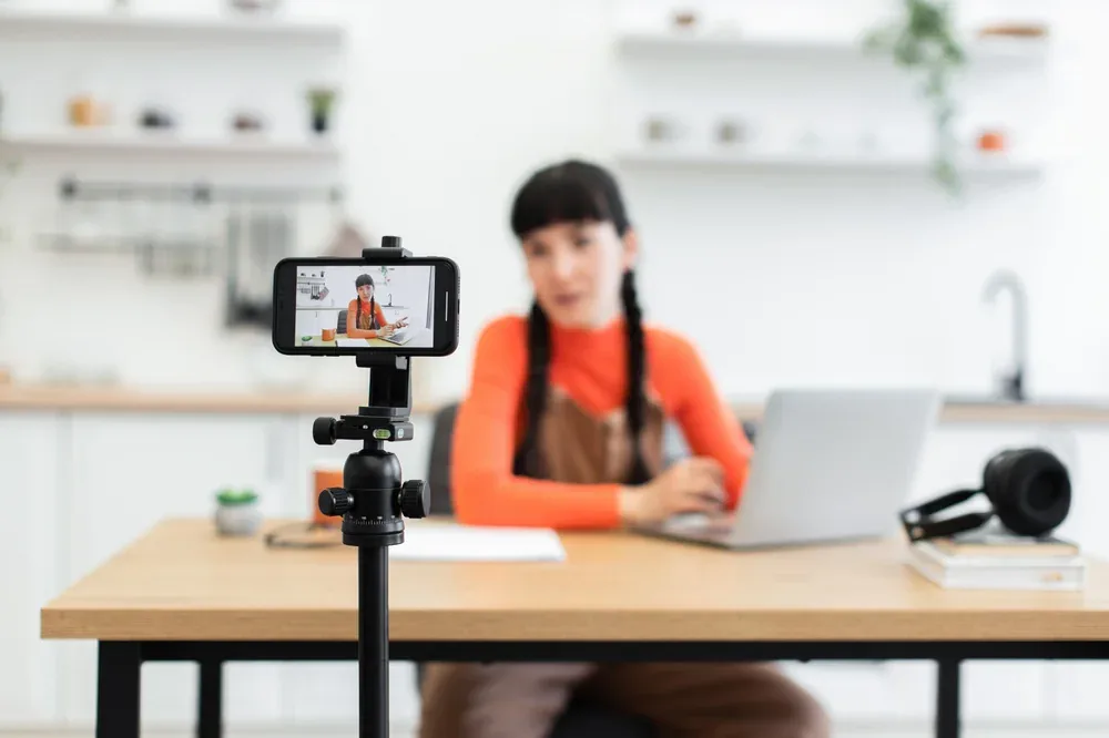 Smartphone on a tripod recording a content creator for social media video