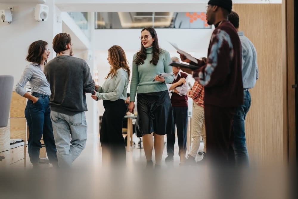 Corporate team members conversing in a modern office