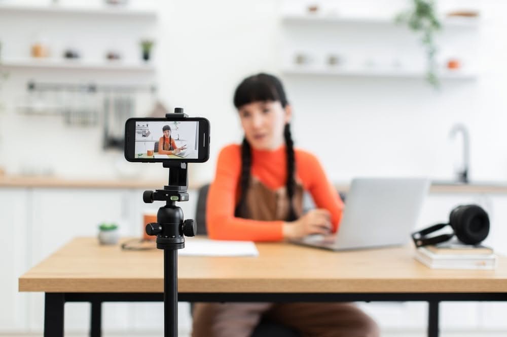 Smartphone on a tripod recording a content creator for social media video